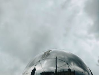 Low angle view of glass building against sky