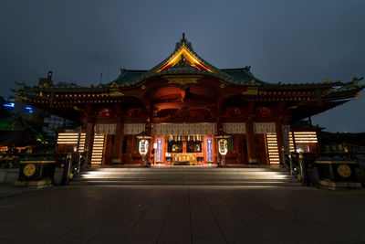 Illuminated temple building against sky at dusk