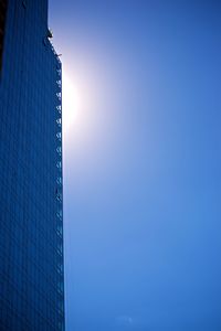 Low angle view of modern buildings against clear blue sky