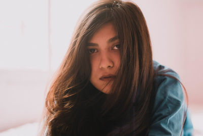 Portrait of woman with brown hair at home