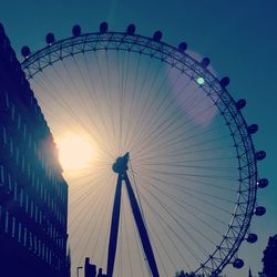 Low angle view of ferris wheel against sky