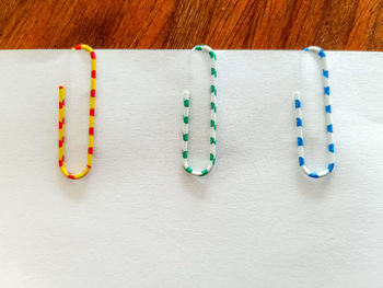 Close-up of paper clip on page at table