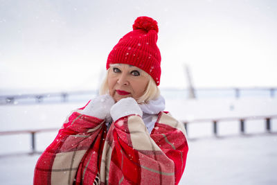 Portrait of senior woman standing outdoors during winter