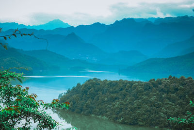 Scenic view of mountains and sea against sky