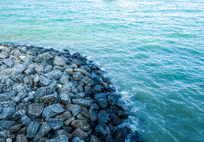 High angle view of rocks on sea