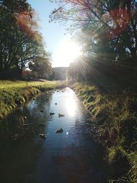 Scenic view of lake against bright sun