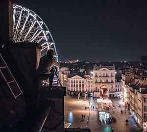 Illuminated cityscape against sky at night