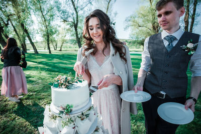 Couple cutting cake during wedding ceremony