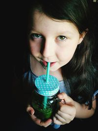 Portrait of girl drinking drink