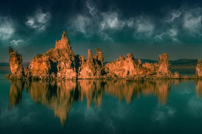 Scenic view of lake by trees against sky