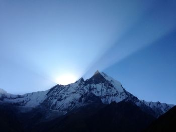 Scenic view of snowcapped mountains against clear blue sky