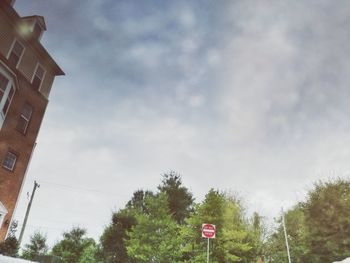 Low angle view of road sign against sky