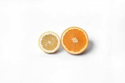 Close-up of orange fruit against white background