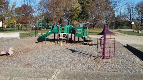 Playground in park against sky