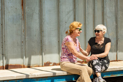 Two elderly women are happy to meet each other