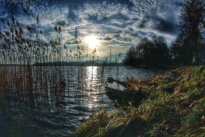 Scenic view of lake against cloudy sky