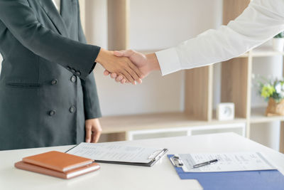 Midsection of man standing on table
