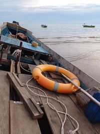 High angle view of boats moored at sea shore against sky