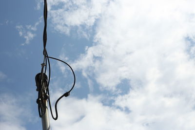 Low angle view of hanging against sky