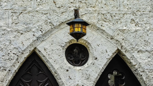 Low angle view of electric lamp on wall