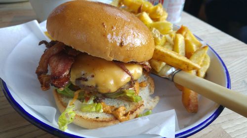 Close-up of burger and vegetables on plate