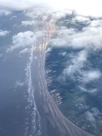 Aerial view of sea and mountains against sky