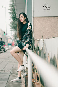 Portrait of young woman sitting outdoors