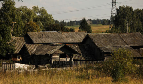 Houses on field against sky