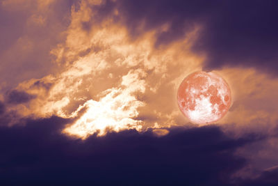 Low angle view of moon against sky at sunset