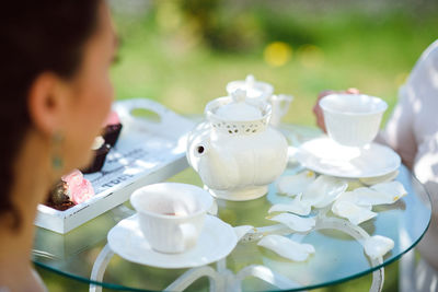 Midsection of woman sitting on table