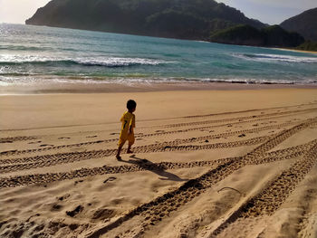 Boy running at the beach