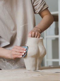 Ceramist woman working with clay at studio