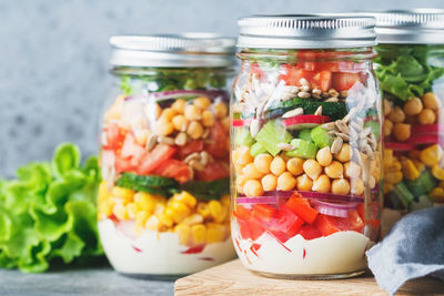 Close-up of vegetables in glass jars on table