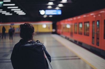 Rear view of woman boarding metro