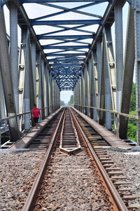 Woman walking on railway bridge
