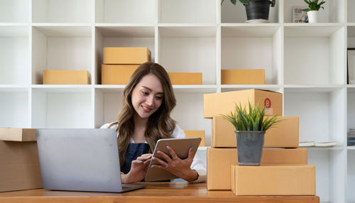 Portrait of woman using laptop at table