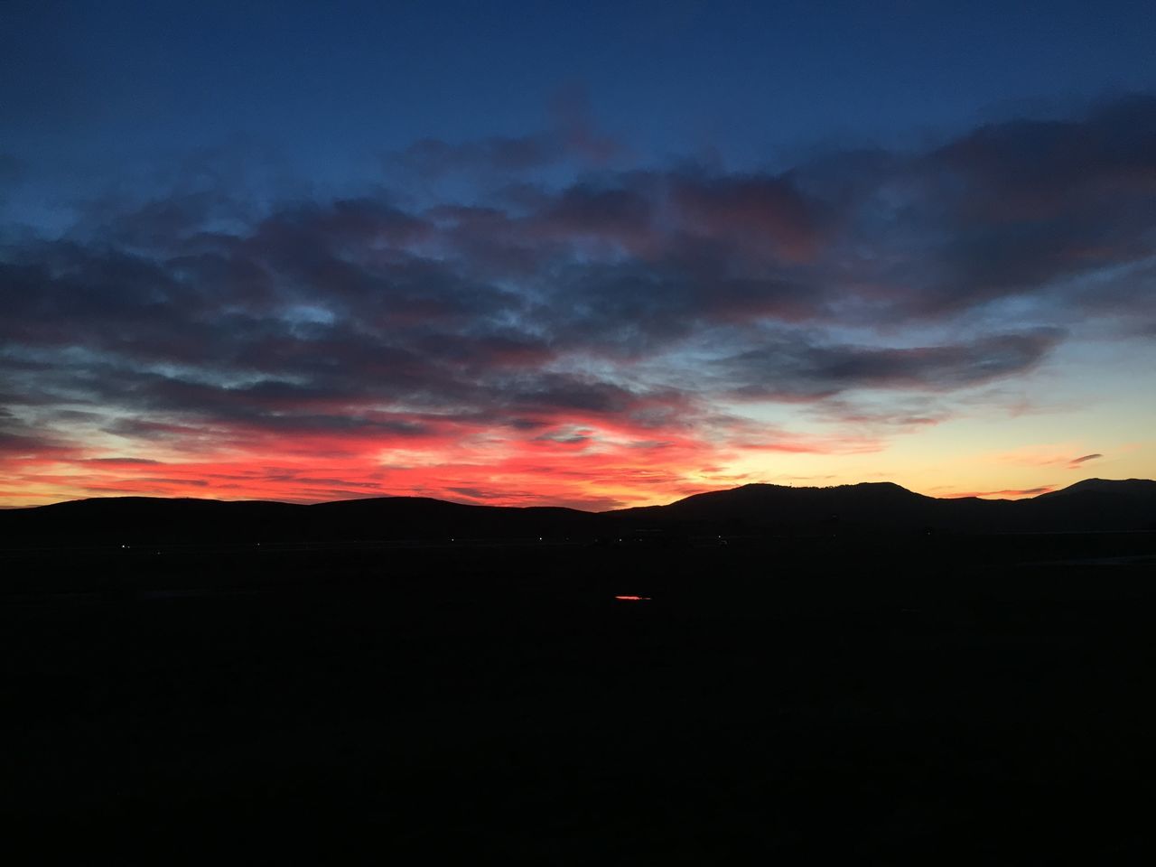 sunset, silhouette, scenics, sky, beauty in nature, tranquil scene, tranquility, cloud - sky, dark, landscape, dramatic sky, orange color, nature, mountain, idyllic, cloud, dusk, moody sky, majestic, cloudy