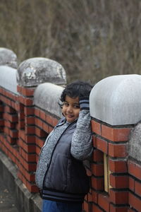 Portrait of boy standing in snow