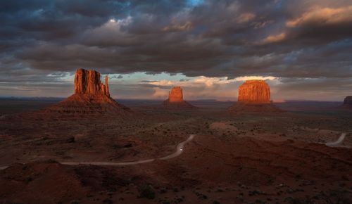 Scenic view of desert against sky during sunset