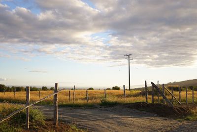 Fence on field against sky