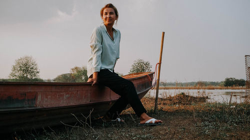 Portrait of young woman standing on field