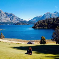 Woman sitting on lakeshore