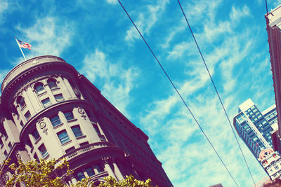 Low angle view of building against cloudy sky