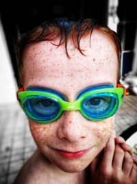 Close-up portrait of boy with freckles wearing swimming goggles