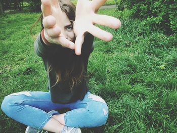 High angle view of woman hands on grass