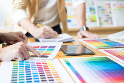 People analyzing color swatch in office