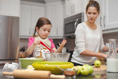 Portrait of happy mother and daughter at home