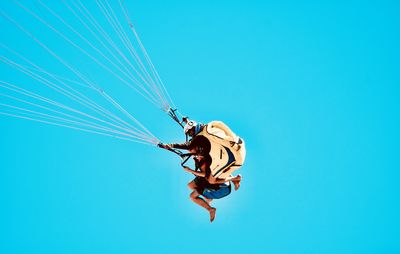 Low angle view of man against blue sky