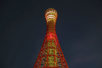 Low angle view of illuminated tower against sky at night