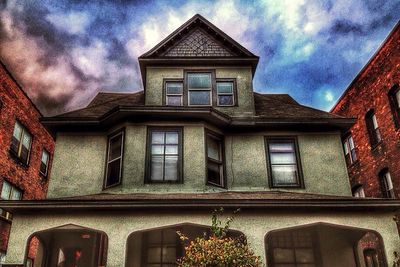 Low angle view of building against cloudy sky